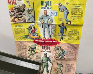 Closer view of the incredible rare vintage 1964 G.I. JOE action figure with multiple outfits (including camouflage, sailor, dress uniform, soldier, et al) and supplies including combat trailer, helmets, rifles, ammo belts, boots, underwater diving helmet, stretcher, lifejacket, and comes with original 1960s Hasbro G.I. Joe Action Soldier toy catalog.The poster features available action figures and their accessory sets for the 1964 catalogue year, including Army, Navy, Air Force, and Marine branches.