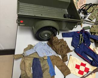 Closer view of the incredible rare vintage 1964 G.I. JOE action figure with multiple outfits (including camouflage, sailor, dress uniform, soldier, et al) and supplies including combat trailer, helmets, rifles, ammo belts, boots, underwater diving helmet, stretcher, lifejacket, and comes with original 1960s Hasbro G.I. Joe Action Soldier toy catalog.The poster features available action figures and their accessory sets for the 1964 catalogue year, including Army, Navy, Air Force, and Marine branches.