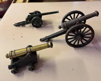 Vintage-style miniature cannons, one is a Britains, the other two are iron and brass, bought as souvenirs at Colonial Williamsburg in the 1960s.