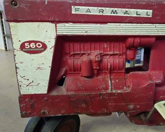 Closeup of the vintage McCormick Farmall 560 pedal tractor.