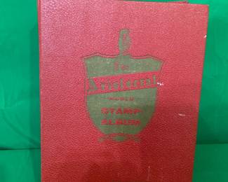 THE ARISTOCRAT WORLD STAMP ALBUM W/SEVERAL STAMPS