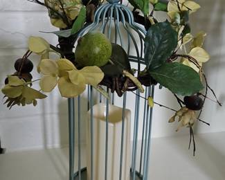 Blue birdcage with floral arrangement