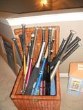 Alot of baseball equipment, bats, balls, hats, uniforms. Alot