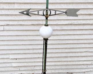 Antique lightning rod with weathervane in garage