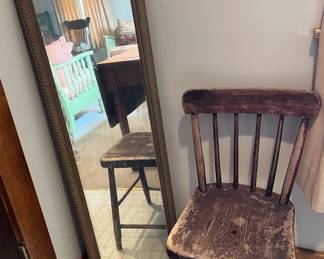 Vintage chair and antique tall mirror in the guest house