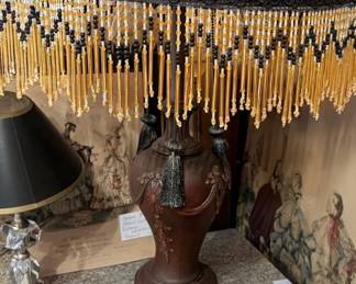 Antique table lamp with beaded and fringe shade in main house