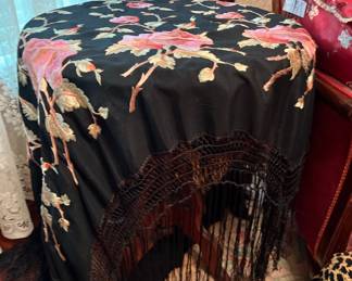 Antique round table and antique fringed scarf in main house