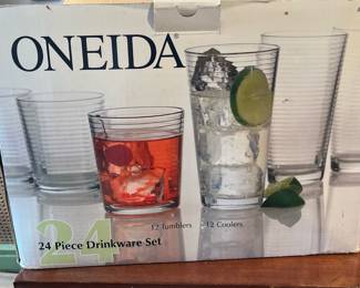 Box full of Oneida glass drinking glasses in guest house