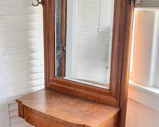 Antique hall tree with hooks and beveled glass mirror in the main house