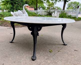 Rot iron base with marble top coffee table in garage