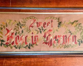 Antique needlepoint in German on punch paper, frame framed. In main house.