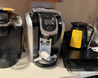 Two Keurig, coffee makers, and accessories in guest house
