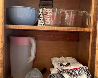 Measuring cups,, cheese, grater, and other kitchen items in guest house