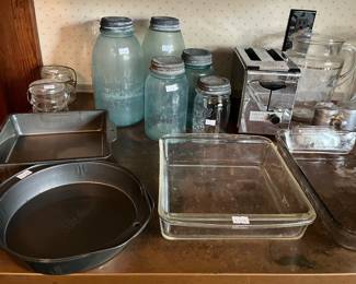 Antique blue canning jars, vintage Westinghouse, toaster, cookie jar, enamel roaster, flatware, glass, and metal baking pans in the main house
