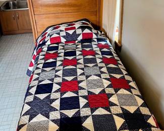 Complete twin size antique bed and quilt in guest house