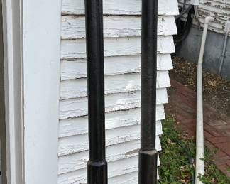 Two antique hitching posts in garage