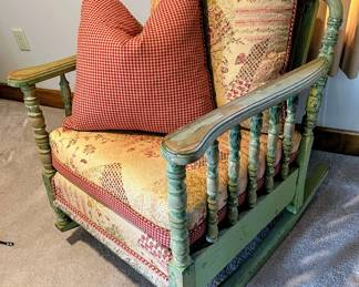 Spindle style upholstered rocking chair with cane back in the guest house
