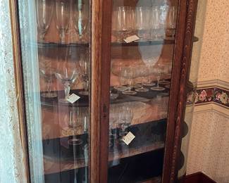 Antique curved glass China cabinet in main house