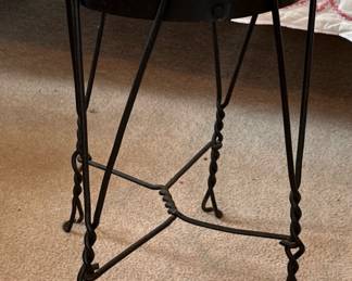 Twisted metal with wood top antique stool in guest house