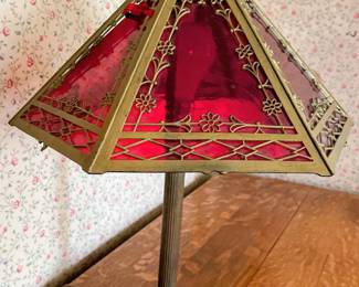 Art deco table lamp in main house. Is missing one red glass panel.