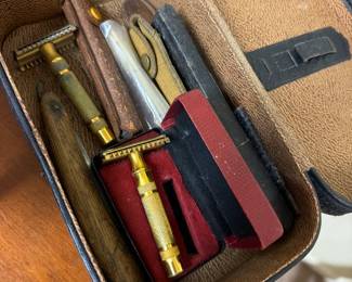 Old shaving implements and tools in leather case, some in solid brass