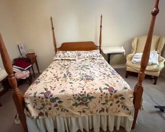 Four poster reproduction full size bed in honey maple covered in imported crewel embroidery coverlet