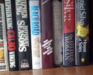 Collection of Stephen King, John le Carré, and Daniel Silva Novels
