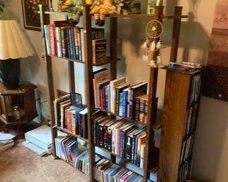 Shelf, DVDs, CDs, books, decor, raggedy, Ann, and Andy, sculptures, and more