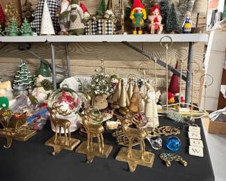 Assorted Christmas Decorations including Ceramic Trees, Gnomes, and Brass Reindeer Stocking Holders