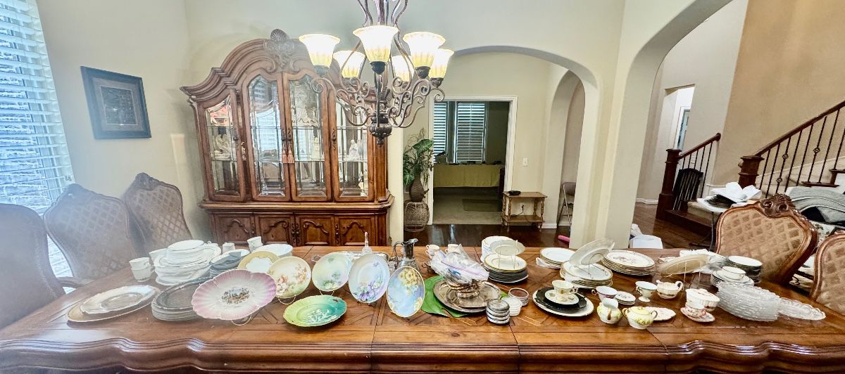 Mega dining table topped with a multitude of fine china