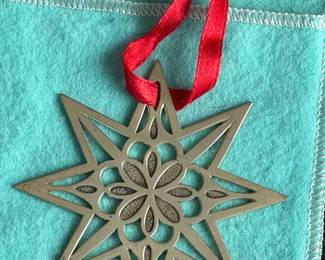 Vintage Tiffany & Co. Sterling Star Ornament (1999) Elegant 8-pointed sterling silver star holiday ornament with a textured floral-center motif.