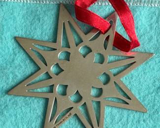Vintage Tiffany & Co. Sterling Star Ornament (1999) Elegant 8-pointed sterling silver star holiday ornament with a textured floral-center motif.