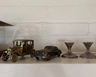 Antique cars & weighted sterling silver candlesticks.