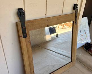 Mirror that hangs on a track