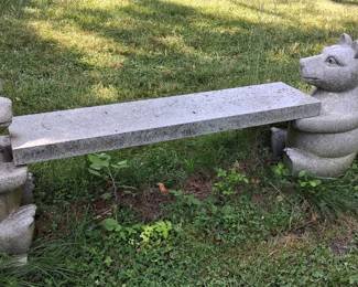 whimsical stone bench designed to resemble two bears facing each other