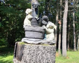 Dogs at a well garden statue