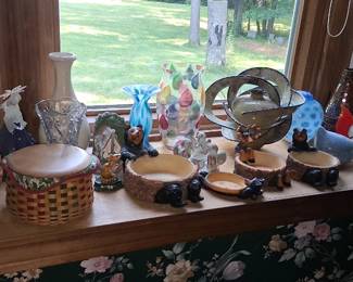 collection features various decorative items, including colorful art glass vases, resin bear-themed planters, and woven baskets.