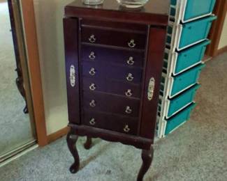 One of two jewelry cabinets with doors on the side