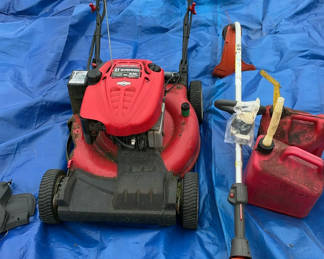 Lot 148: Gas-powered lawn mower and string trimmer with fuel container