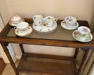 Bamboo console table with cane lower tier, and English tea cups/saucers