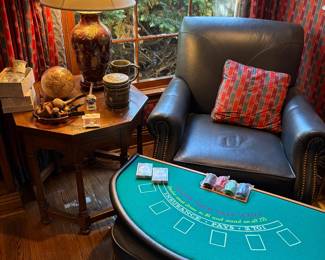 Blue leather club chair with ottoman (matched set of 2 available), octagonal wood table, ceramic table lamp with gold motif, Black Jack players board, with pipes, globe and ceramic tobacco jar and beer stein