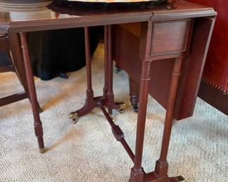 Another view of the drop-leaf side table with brass foot