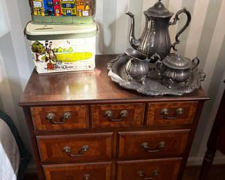 4-drawer dresser shown with silver-plated tea set and vintage collage purses