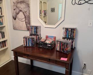 Lots of DVDS and CDS, writing desk