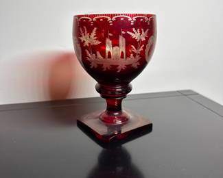 C28 - $15. Cut to Clear Red Glass. Has chip on the underside of the base. Castle carved on one side and a deer on the other.