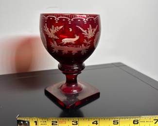 C28 - $15. Cut to Clear Red Glass. Has chip on the underside of the base. Castle carved on one side and a deer on the other.