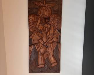 C10 - $30. Carved Relief Wall Art. Measures 12" x 27.5" tall.