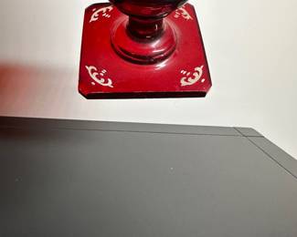 C28 - $15. Cut to Clear Red Glass. Has chip on the underside of the base. Castle carved on one side and a deer on the other.