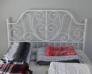 White metal full bed, linens