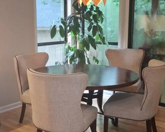 Round Dining Table with Hammered Copper Inlay and Upholstered Chairs